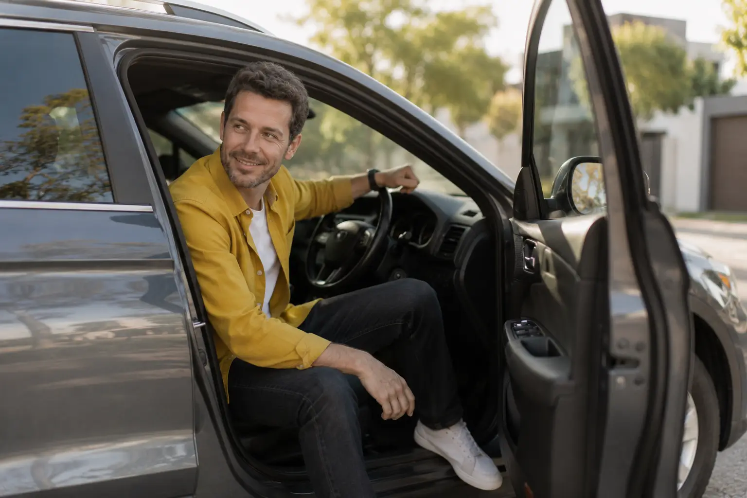 Relaxed man in a parked SUV