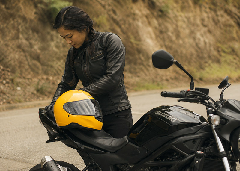 Focused rider and black Suzuki bike